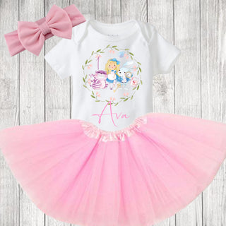 Enchanting Alice in Wonderland birthday outfit featuring a whimsical design. Choose the top only or the complete set with tutu and bow. Crafted with care and available in various sizes for a magical celebration.