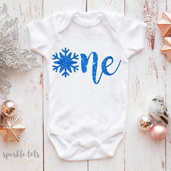 Snowflake Charming 1st Birthday Snowflake Baby Vest from Sparkle Tots – a festive and comfortable piece adorned with delicate snowflake patterns for your baby's memorable celebration.